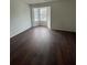 This bedroom features dark wood floors and a large bay window with natural light at 465 Prince Of Wales, Stone Mountain, GA 30083