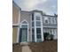 Charming townhome featuring a lovely blue door, light gray siding and a bay window at 465 Prince Of Wales, Stone Mountain, GA 30083