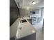 Updated kitchen with modern white countertops, gray cabinets, and stainless faucet at 465 Prince Of Wales, Stone Mountain, GA 30083