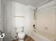 Cozy bathroom features a toilet and a tiled bathtub with showerhead at 1321 Keys Lake Ne Dr, Brookhaven, GA 30319