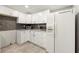 Well lit kitchen with white cabinets, granite countertops and stainless steel appliances at 1321 Keys Lake Ne Dr, Brookhaven, GA 30319
