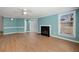 Bright living room featuring wood floors, fireplace, modern ceiling fan, and lovely contrasting trim at 1321 Keys Lake Ne Dr, Brookhaven, GA 30319