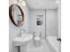 Updated bathroom features a round mirror and modern fixtures at 2195 Burroughs Ave, Atlanta, GA 30315
