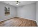 This bedroom offers hardwood floors, a ceiling fan, and natural light at 2195 Burroughs Ave, Atlanta, GA 30315