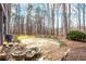 Stone patio and stone water feature in natural backyard setting with mature trees at 285 Blackstock Rd, Villa Rica, GA 30180