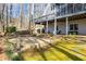 View of backyard with stone patio, stone water feature, and deck at 285 Blackstock Rd, Villa Rica, GA 30180