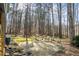 Stone patio and stone water feature in natural backyard setting with mature trees at 285 Blackstock Rd, Villa Rica, GA 30180
