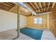 Unfinished basement with exposed wooden beams, duct work, and a cozy blue rug at 285 Blackstock Rd, Villa Rica, GA 30180