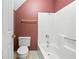 Bathroom featuring shower, toilet, and decorative wallpaper at 285 Blackstock Rd, Villa Rica, GA 30180
