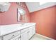 Bathroom with vanity, decorative mirror, and wallpaper at 285 Blackstock Rd, Villa Rica, GA 30180