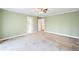 View of a bedroom with a ceiling fan and doorways leading to a bathroom and hallway at 285 Blackstock Rd, Villa Rica, GA 30180