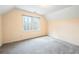 Bedroom with a large window overlooking a wooded area and tan walls at 285 Blackstock Rd, Villa Rica, GA 30180