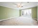 Spacious bedroom with carpet flooring, ceiling fan, and access to a balcony through sliding glass doors at 285 Blackstock Rd, Villa Rica, GA 30180