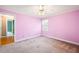 A bright bedroom with a ceiling fan, a window letting in natural light, and a doorway to another room at 285 Blackstock Rd, Villa Rica, GA 30180