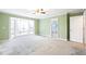 Sunlit bedroom featuring large windows with access to a deck overlooking trees at 285 Blackstock Rd, Villa Rica, GA 30180