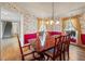 Charming dining room featuring hardwood floors, floral wallpaper, and a view of the staircase at 285 Blackstock Rd, Villa Rica, GA 30180