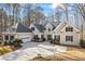 Beautiful home featuring a gray facade, black shutters, attached garage, and well-manicured shrubs at 285 Blackstock Rd, Villa Rica, GA 30180