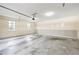 An empty two car garage features wainscotting, two windows, and ample space at 285 Blackstock Rd, Villa Rica, GA 30180