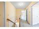 A tan hallway with wood railings, skylight and doorways to adjacent rooms at 285 Blackstock Rd, Villa Rica, GA 30180