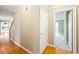 Hallway with hardwood floors, doorway, and staircase leading to upper level in a well-lit space at 285 Blackstock Rd, Villa Rica, GA 30180