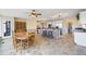 Open floor plan with kitchen island with stone accents, dining table and sunroom at 285 Blackstock Rd, Villa Rica, GA 30180