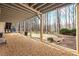 Covered patio with gravel floor leading to backyard with stone water feature at 285 Blackstock Rd, Villa Rica, GA 30180