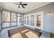 Comfortable screened porch with ceiling fan and views of the surrounding woods at 285 Blackstock Rd, Villa Rica, GA 30180