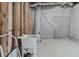 Unfinished basement featuring concrete walls, exposed beams, and a utility sink, ready for customization at 160 Antler Trl, Alpharetta, GA 30005