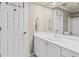 Bright bathroom featuring a single sink vanity with white cabinets, a large mirror, and tile floors at 160 Antler Trl, Alpharetta, GA 30005