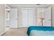 Cozy bedroom featuring double door closet and entry to bath and hallway at 160 Antler Trl, Alpharetta, GA 30005