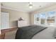 Bright bedroom featuring a ceiling fan, dresser, and a large window overlooking the scenic outdoors at 160 Antler Trl, Alpharetta, GA 30005