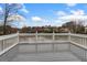 Spacious deck offering a serene view of the lake and surrounding greenery, perfect for outdoor enjoyment at 160 Antler Trl, Alpharetta, GA 30005