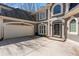Close up of the house with its long driveway, manicured landscaping, and a two-car garage at 160 Antler Trl, Alpharetta, GA 30005