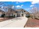 Stately two-story home with a long driveway, manicured landscaping, and a three-car garage at 160 Antler Trl, Alpharetta, GA 30005