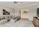 Comfortable living room featuring contemporary furnishings and view to the kitchen at 160 Antler Trl, Alpharetta, GA 30005