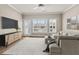 Sun-filled living room with neutral color scheme, decorative art, and view to back yard at 160 Antler Trl, Alpharetta, GA 30005