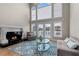 Bright living room features a fireplace, hardwood floors, and large windows with a door leading to a small balcony at 160 Antler Trl, Alpharetta, GA 30005