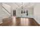 Living room with hardwood floors, a staircase, a decorative front door, and wainscoting at 160 Antler Trl, Alpharetta, GA 30005