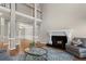 Spacious living room with fireplace, hardwood floors, and an open layout with a view of the dining room from the balcony above at 160 Antler Trl, Alpharetta, GA 30005