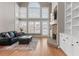 Comfortable living room offers ample light, wood floors, built-in shelves, and a stone fireplace at 160 Antler Trl, Alpharetta, GA 30005