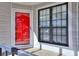 Balcony with grey railings and a red front door with a matching red screen door at 586 Windchase Ln, Stone Mountain, GA 30083