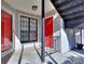 Balcony with grey railings and a red front door with a matching red screen door at 586 Windchase Ln, Stone Mountain, GA 30083