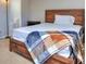 Cozy bedroom with a wood bed frame and a soft, patterned blanket at 586 Windchase Ln, Stone Mountain, GA 30083