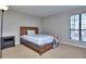Bedroom featuring a wood bed frame, a nightstand, and a window at 586 Windchase Ln, Stone Mountain, GA 30083