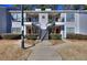 Attractive condo complex featuring neat landscaping, symmetrical stairs, and neutral paint at 586 Windchase Ln, Stone Mountain, GA 30083