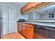 Galley kitchen with stainless steel appliances, warm-toned cabinets, and tile flooring at 586 Windchase Ln, Stone Mountain, GA 30083