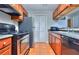 Galley kitchen with stainless steel appliances, tile flooring, and ample cabinet space at 586 Windchase Ln, Stone Mountain, GA 30083