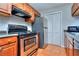 Galley kitchen with stainless steel appliances, tile flooring, and warm-toned cabinets at 586 Windchase Ln, Stone Mountain, GA 30083