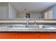 Kitchen sink in a home with wood cabinets and an opening into the living room at 586 Windchase Ln, Stone Mountain, GA 30083