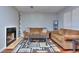 Inviting living room with fireplace, plush sofas, hardwood flooring, and stylish rug at 586 Windchase Ln, Stone Mountain, GA 30083
